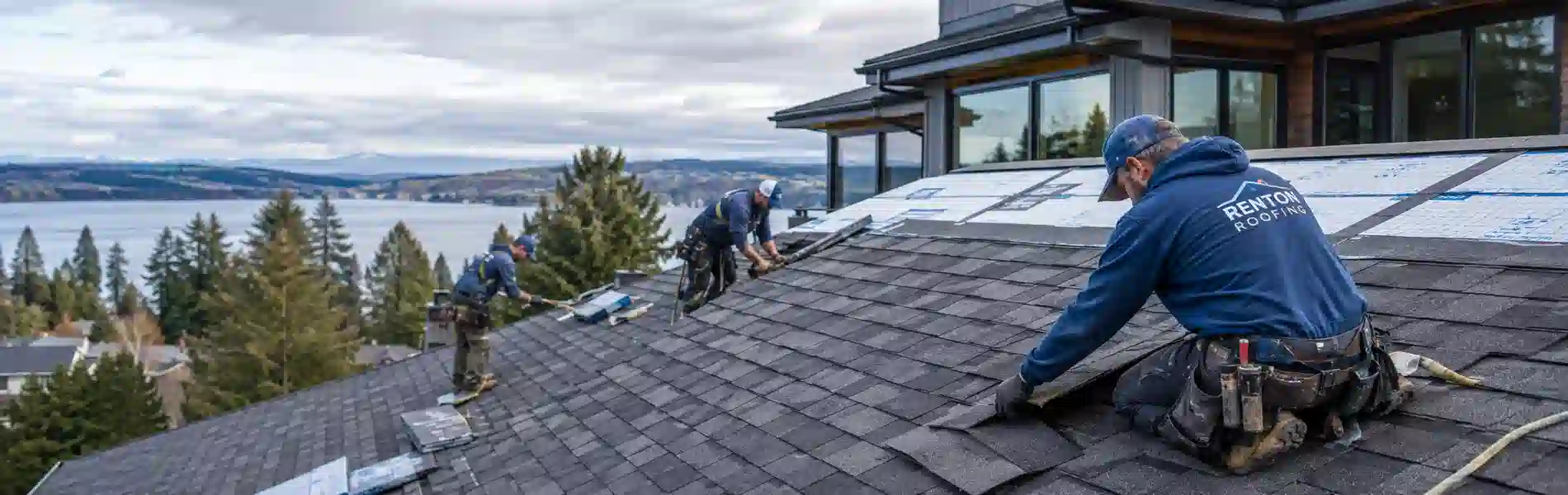Renton Roofing crew installing underlayment on a shingle roof